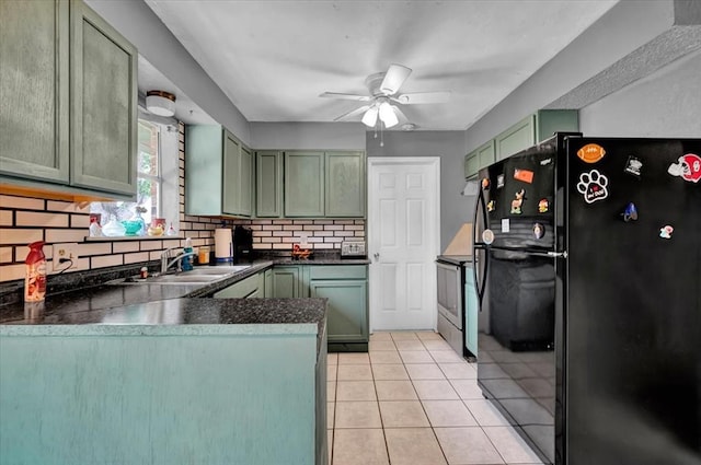 1017 Linn Ln, Yukon, OK 73099 - kitchen with freestanding refrigerator, backsplash, dark countertops, and green cabinets