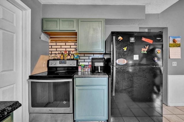 1017 Linn Ln, Yukon, OK 73099 - kitchen featuring freestanding refrigerator, electric stove, tasteful backsplash, and dark countertops