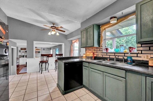 1017 Linn Ln, Yukon, OK 73099 - kitchen featuring dishwasher, green cabinetry, vaulted ceiling, dark countertops, and light tile patterned flooring
