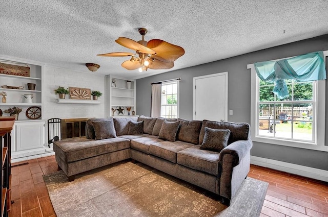 1017 Linn Ln, Yukon, OK 73099 - living room featuring wood finished floors, a textured ceiling, and ceiling fan