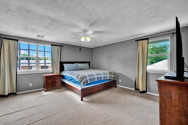 1017 Linn Ln, Yukon, OK 73099 - carpeted bedroom featuring a ceiling fan and a textured ceiling