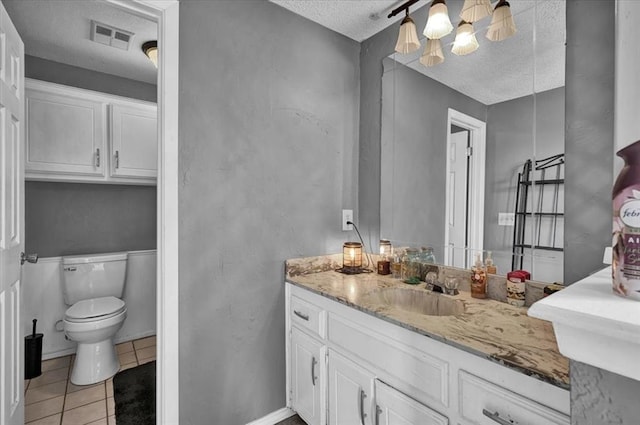 1017 Linn Ln, Yukon, OK 73099 - bathroom featuring a textured ceiling, vanity, tile patterned floors, and a chandelier