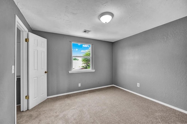 1017 Linn Ln, Yukon, OK 73099 - empty room featuring a textured wall, carpet floors, and a textured ceiling