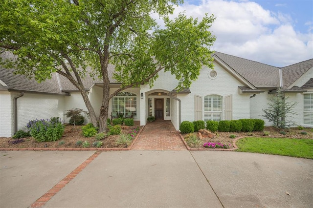 305 Carmel Valley Way, Edmond, OK 73025 - view of front of house featuring brick siding and roof with shingles