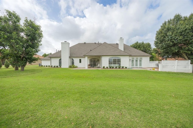 305 Carmel Valley Way, Edmond, OK 73025 - rear view of house featuring a patio area, french doors, a chimney, and roof with shingles