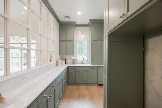 305 Carmel Valley Way, Edmond, OK 73025 - kitchen with light wood-type flooring, green cabinetry, crown molding, and recessed lighting