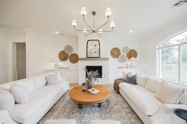 305 Carmel Valley Way, Edmond, OK 73025 - living area with a chandelier, crown molding, recessed lighting, a fireplace, and wood finished floors