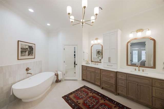 305 Carmel Valley Way, Edmond, OK 73025 - full bath with a chandelier, double vanity, a freestanding bath, ornamental molding, and recessed lighting