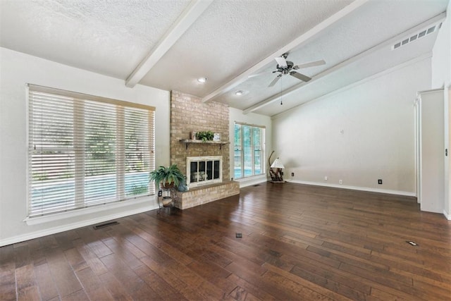 4424 Brighton Ct, Norman, OK 73072 - unfurnished living room featuring a textured ceiling, ceiling fan, wood-type flooring, and a brick fireplace