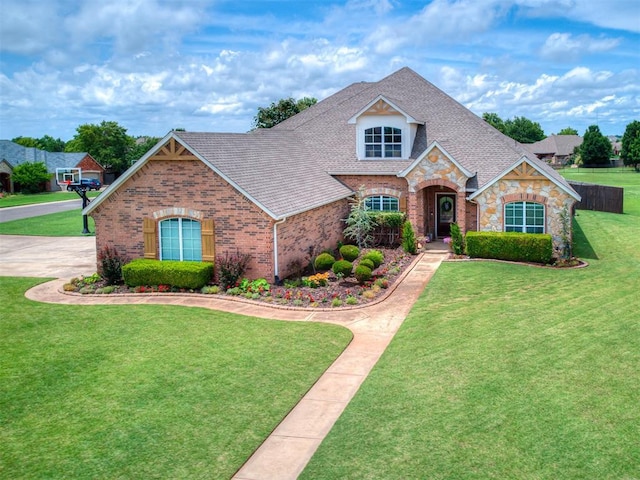 7821 Lindsay Ln, Edmond, OK 73025 - view of front facade with stone siding, a front lawn, brick siding, and a shingled roof