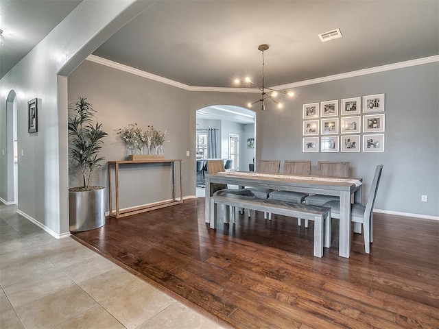 7821 Lindsay Ln, Edmond, OK 73025 - tiled dining area with arched walkways and ornamental molding