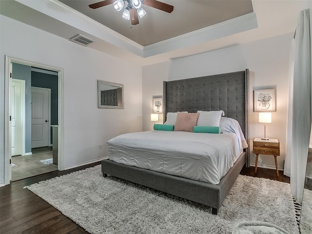 7821 Lindsay Ln, Edmond, OK 73025 - bedroom with wood finished floors, crown molding, a tray ceiling, and ceiling fan
