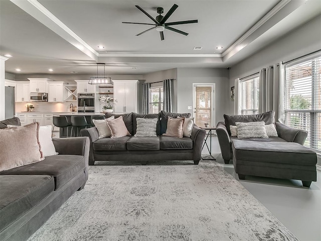 7821 Lindsay Ln, Edmond, OK 73025 - living area with ceiling fan, a tray ceiling, ornamental molding, and recessed lighting