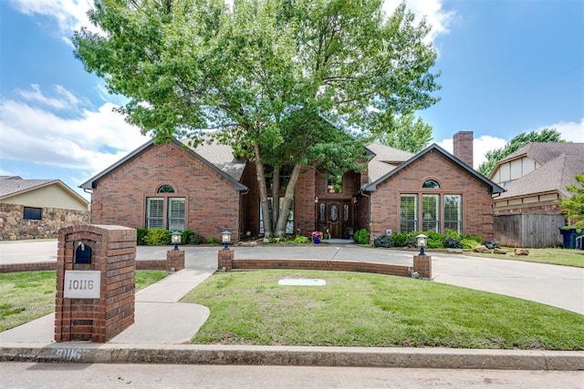 10116 Thompson Ave, Yukon, OK 73099 - english style home featuring brick siding and a chimney
