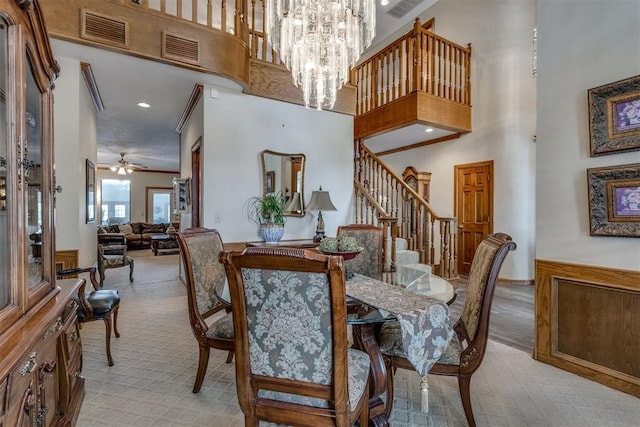 10116 Thompson Ave, Yukon, OK 73099 - dining room featuring light carpet, stairs, a towering ceiling, ornamental molding, and a chandelier