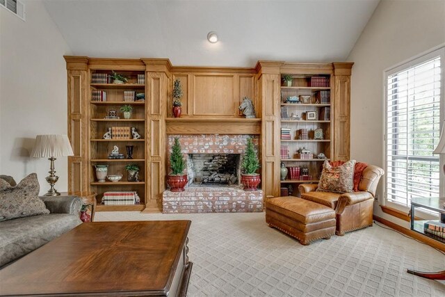 10116 Thompson Ave, Yukon, OK 73099 - living area featuring vaulted ceiling, healthy amount of natural light, a brick fireplace, and light carpet