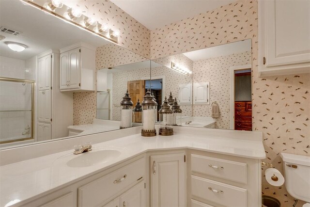 10116 Thompson Ave, Yukon, OK 73099 - bathroom featuring vanity, an enclosed shower, and wallpapered walls