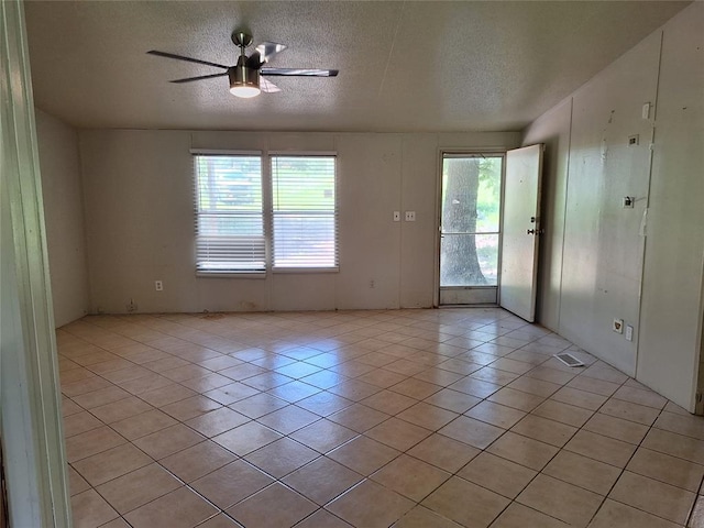 18451 Rolling Oak Rd, Newalla, OK 74857 - spare room with light tile patterned floors, a textured ceiling, and ceiling fan