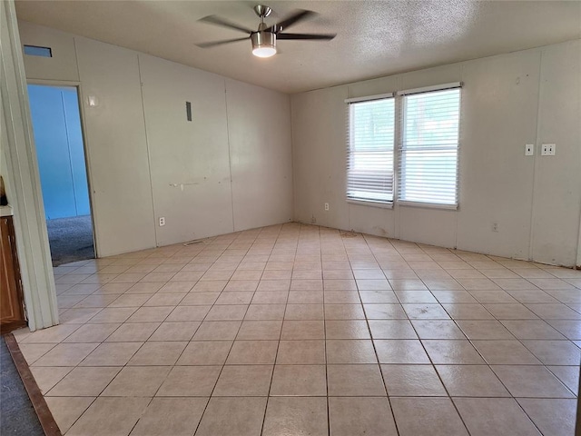 18451 Rolling Oak Rd, Newalla, OK 74857 - spare room featuring a ceiling fan, light tile patterned flooring, and a textured ceiling