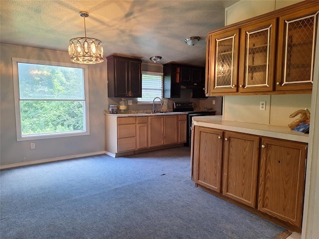 18451 Rolling Oak Rd, Newalla, OK 74857 - kitchen featuring a chandelier, light colored carpet, light countertops, range with electric cooktop, and hanging light fixtures