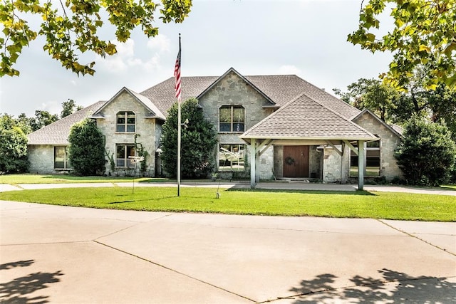 6540 S Donna Ln, Oklahoma City, OK 73150 - french provincial home featuring stone siding, a front lawn, and roof with shingles