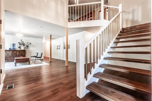 6540 S Donna Ln, Oklahoma City, OK 73150 - stairway featuring wood finished floors, a chandelier, and a high ceiling
