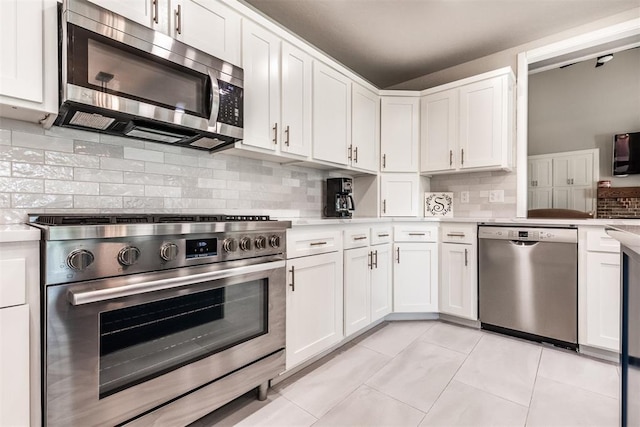 6540 S Donna Ln, Oklahoma City, OK 73150 - kitchen with appliances with stainless steel finishes, light countertops, white cabinetry, decorative backsplash, and light tile patterned flooring