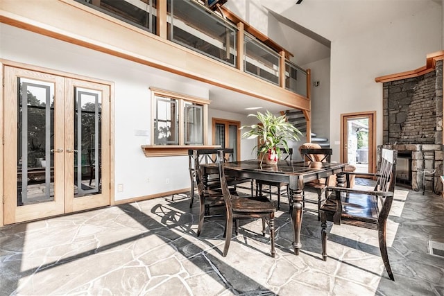 6540 S Donna Ln, Oklahoma City, OK 73150 - dining area with a towering ceiling, french doors, stone flooring, and a stone fireplace