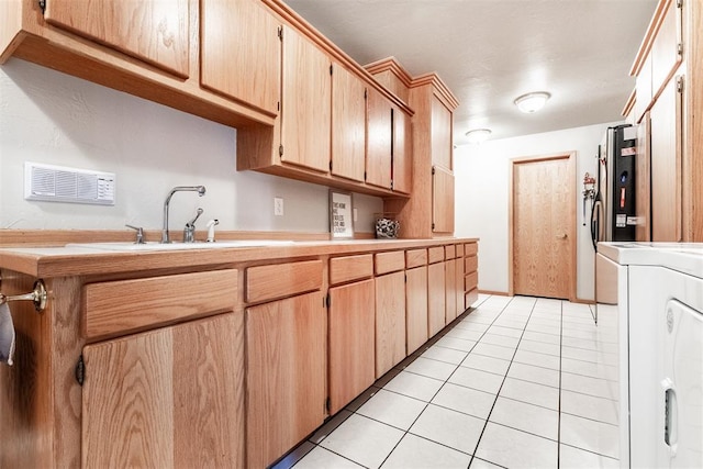 6540 S Donna Ln, Oklahoma City, OK 73150 - kitchen featuring light countertops, light tile patterned floors, and washer / dryer