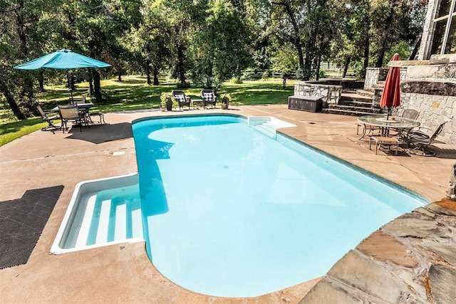6540 S Donna Ln, Oklahoma City, OK 73150 - swimming pool featuring a patio, view of scattered trees, and a lawn