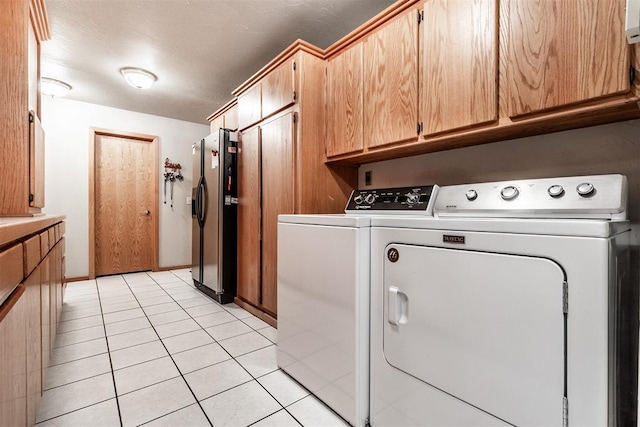 6540 S Donna Ln, Oklahoma City, OK 73150 - laundry room featuring separate washer and dryer, light tile patterned floors, and cabinet space
