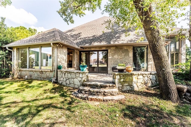 6540 S Donna Ln, Oklahoma City, OK 73150 - rear view of property with stone siding, a shingled roof, and a yard