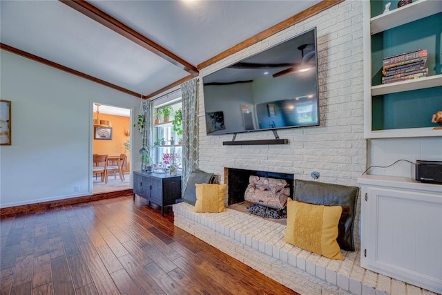 6348 Hyde Park Dr, Oklahoma City, OK 73162 - living area featuring wood finished floors, a brick fireplace, crown molding, and built in shelves