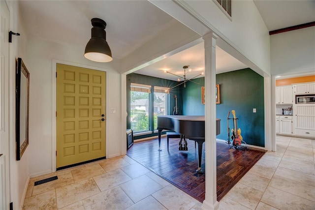 6348 Hyde Park Dr, Oklahoma City, OK 73162 - foyer entrance with baseboards and decorative columns