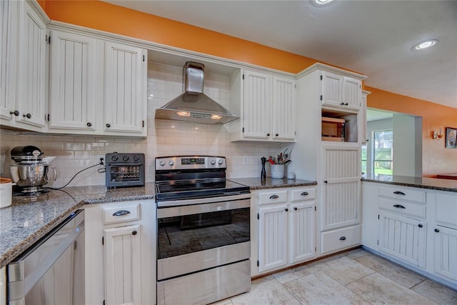 6348 Hyde Park Dr, Oklahoma City, OK 73162 - kitchen with appliances with stainless steel finishes, wall chimney range hood, decorative backsplash, stone counters, and recessed lighting
