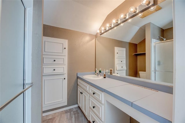 6348 Hyde Park Dr, Oklahoma City, OK 73162 - bathroom with double vanity, an enclosed shower, vaulted ceiling, and a textured wall