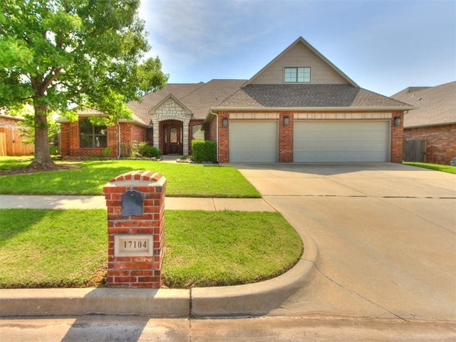 17104 Wales Green Ave, Edmond, OK 73012 - view of front of property with a garage, brick siding, driveway, a front yard, and a shingled roof