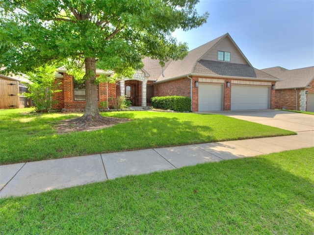 17104 Wales Green Ave, Edmond, OK 73012 - view of front facade featuring concrete driveway, an attached garage, a front yard, and brick siding