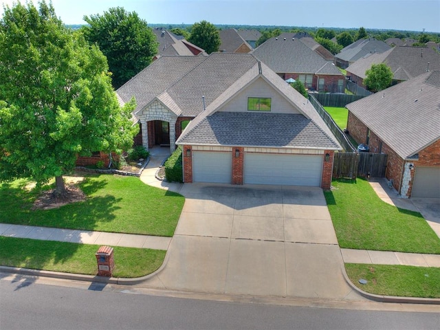 17104 Wales Green Ave, Edmond, OK 73012 - view of front of home with brick siding, concrete driveway, a garage, and a shingled roof