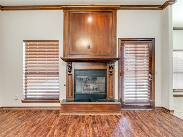17104 Wales Green Ave, Edmond, OK 73012 - detailed view of wood finished floors, ornamental molding, and a fireplace