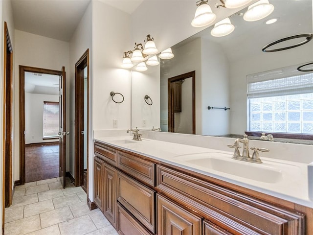 17104 Wales Green Ave, Edmond, OK 73012 - full bathroom with double vanity, tile patterned flooring, and a chandelier