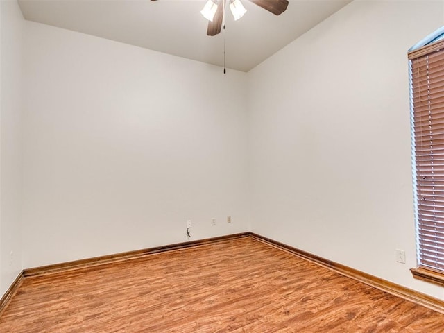 17104 Wales Green Ave, Edmond, OK 73012 - empty room featuring a ceiling fan, wood finished floors, and vaulted ceiling