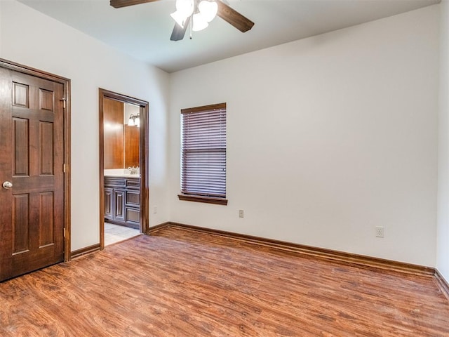 17104 Wales Green Ave, Edmond, OK 73012 - unfurnished bedroom with light wood-type flooring, ceiling fan, and ensuite bath