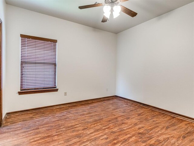 17104 Wales Green Ave, Edmond, OK 73012 - spare room with wood finished floors and ceiling fan