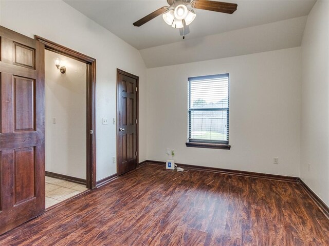 17104 Wales Green Ave, Edmond, OK 73012 - unfurnished bedroom featuring light wood-style flooring, vaulted ceiling, and ceiling fan