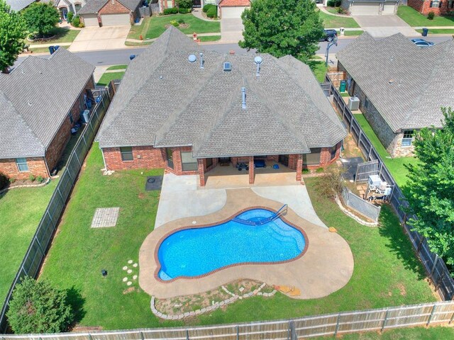 17104 Wales Green Ave, Edmond, OK 73012 - view of swimming pool featuring a fenced backyard, a pool with connected hot tub, a residential view, and a patio area