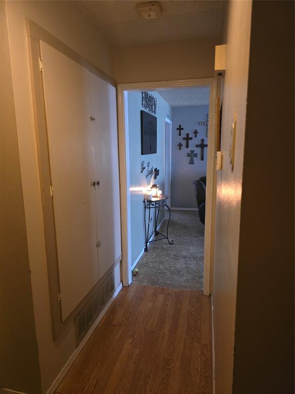 618 Briarwood Ln, Frederick, OK 73542 - hallway featuring wood finished floors and baseboards