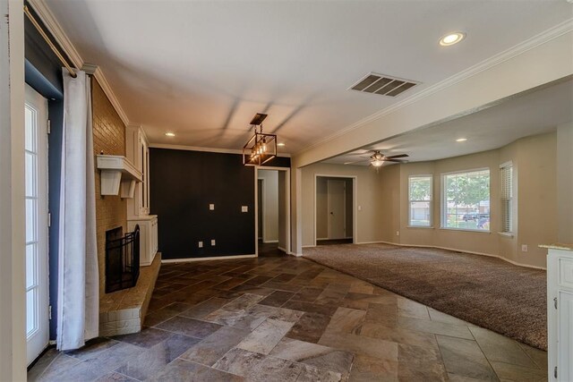 5717 NW 31st Ter, Oklahoma City, OK 73122 - unfurnished living room featuring ornamental molding, a fireplace, stone tile floors, recessed lighting, and a ceiling fan