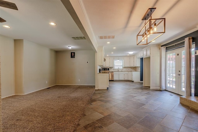 5717 NW 31st Ter, Oklahoma City, OK 73122 - unfurnished living room with recessed lighting, stone tile floors, crown molding, and french doors