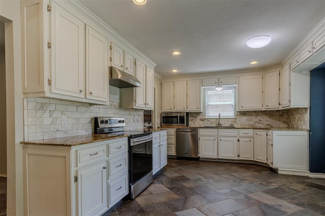 5717 NW 31st Ter, Oklahoma City, OK 73122 - kitchen with stainless steel appliances, under cabinet range hood, backsplash, white cabinets, and recessed lighting